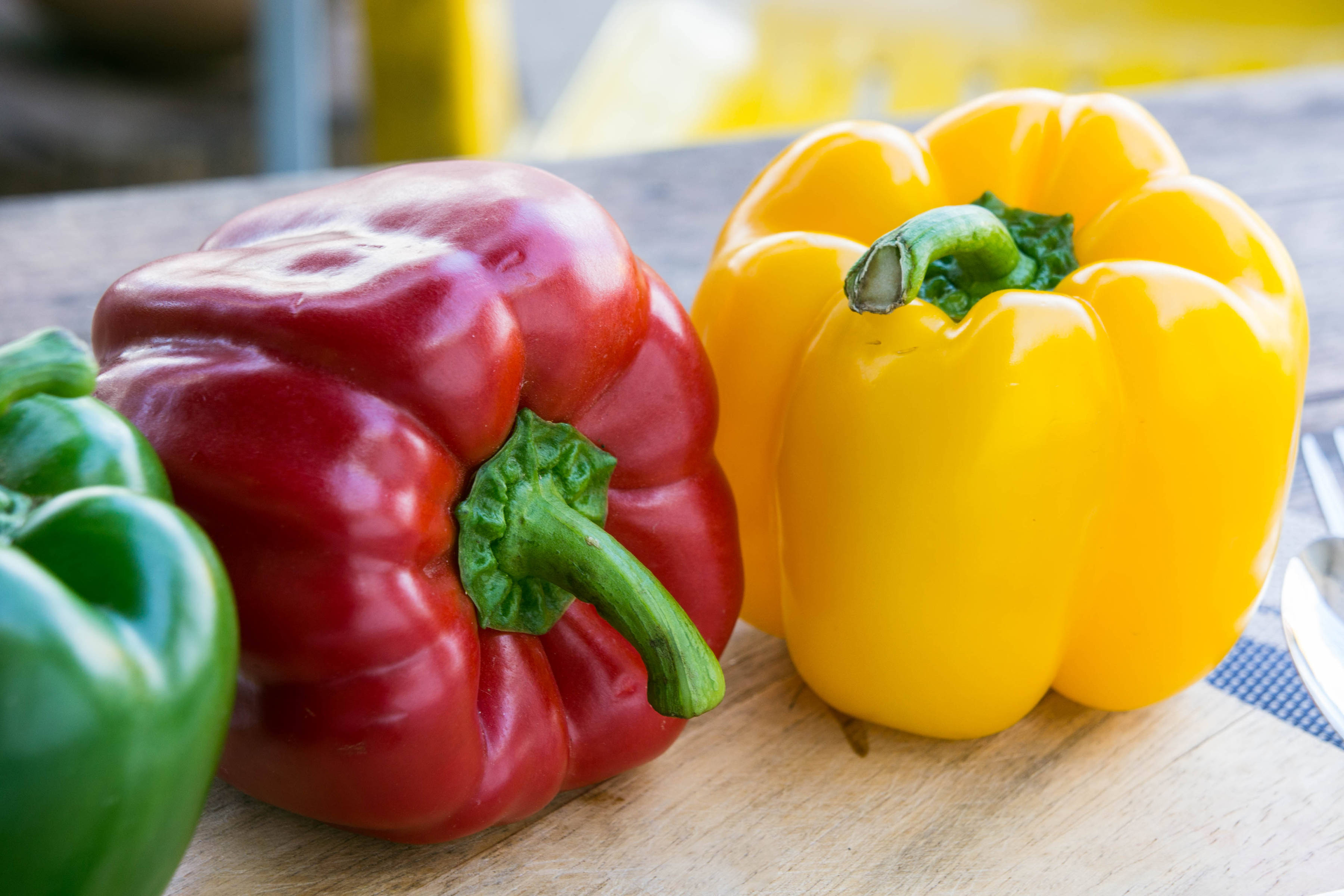 Green, red, and yellow capsicums. Photo: AboutnuyLove / iStock.